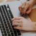 Woman`s hands on the laptop