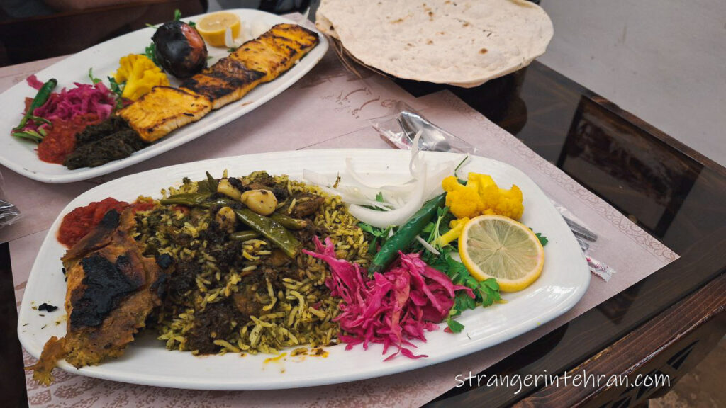 fish kebab and a plate of rice with shrimps and herbs